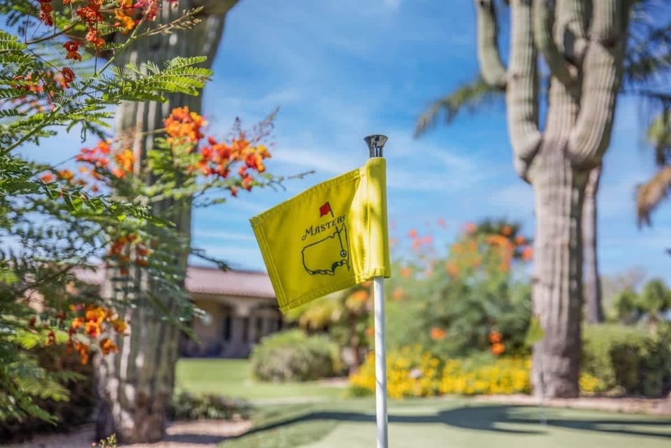 Championship-style putting green with flagstick—practice your stroke in your own backyard.