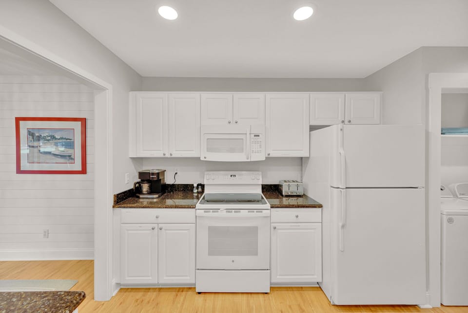 Kitchen with stainless steel appliances and fully stocked.