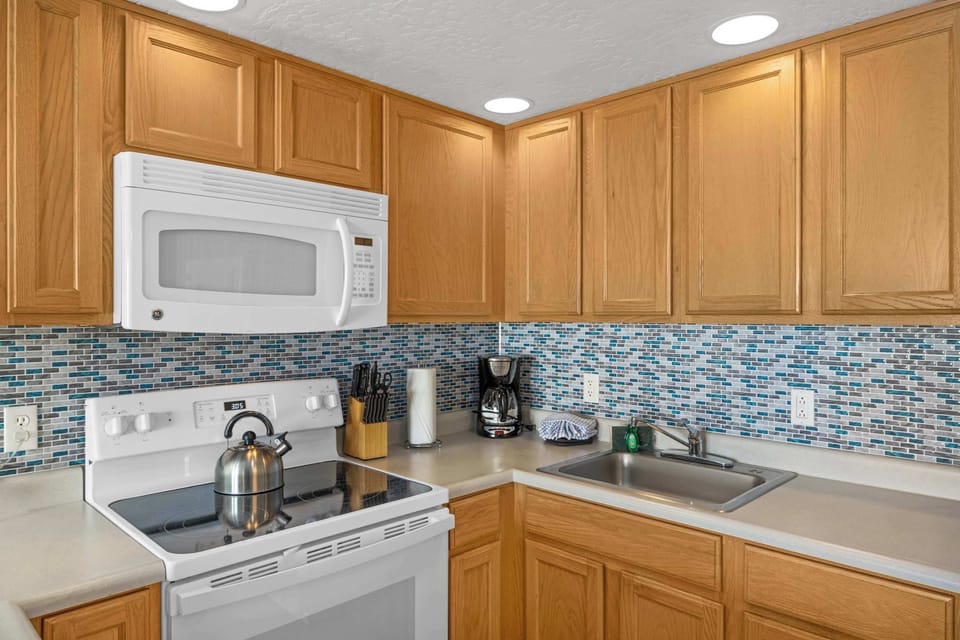 The kitchen is fully stocked with cookware and essentials