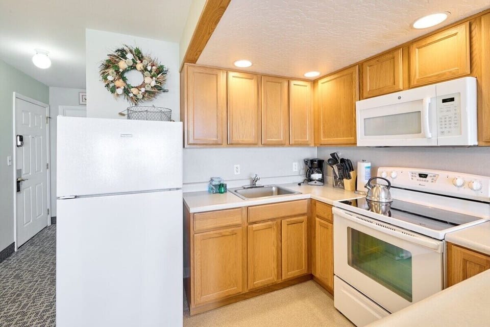 The kitchen comes fully stocked with silverware, pots and pans, plates, appliances, and everything else you need to cook