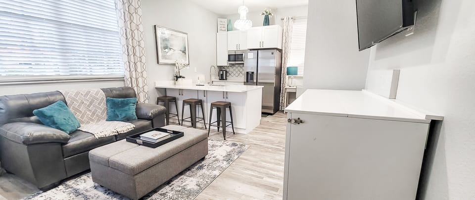 The living room looks into the kitchen & the bar seating allows for flexibility.