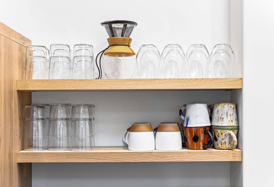 Organized kitchen shelves with stylish glassware and mugs