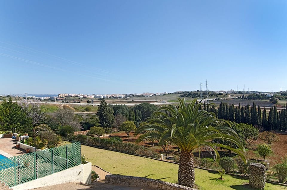 From the upper floor in Villa Lorena you have a view into the large garden as well as Lagos.