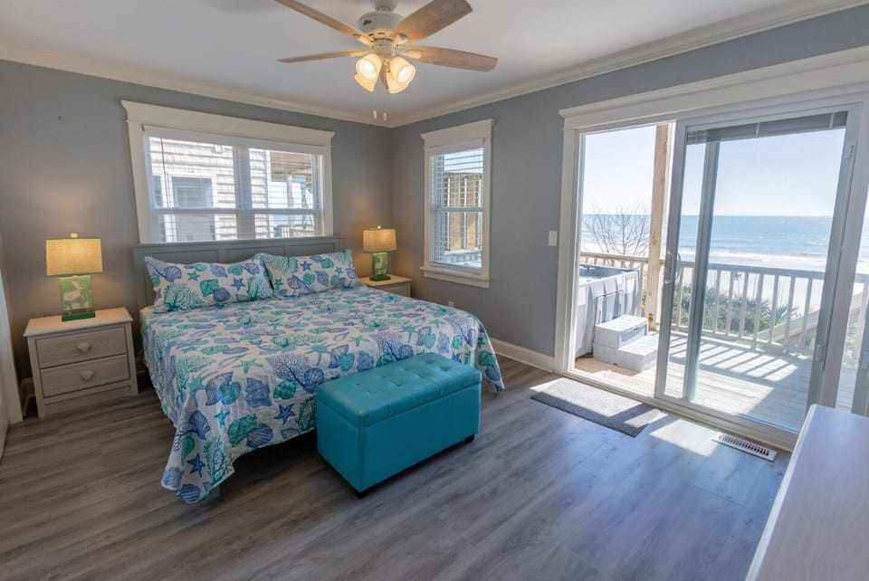 Relax in our king bed by the ocean.