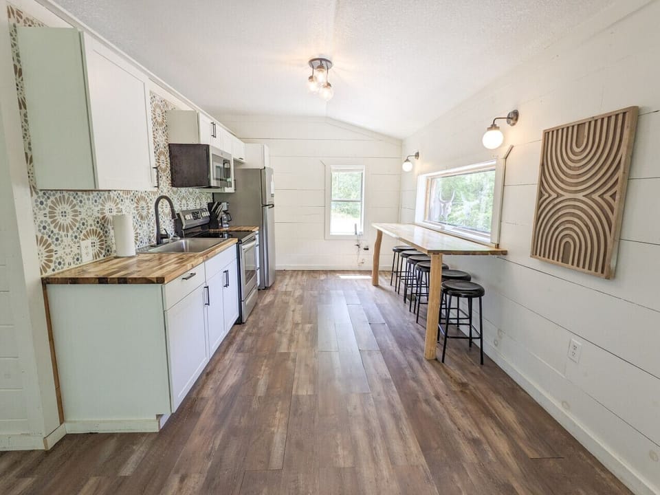 The kitchen is stocked with pots, pans, servingware and utensils.