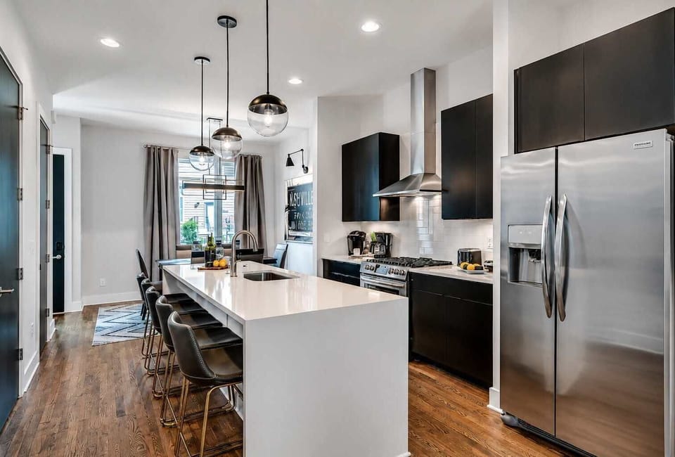 Cook and gather in a sleek, light-filled kitchen with comfortable seating and plenty of space for dining.