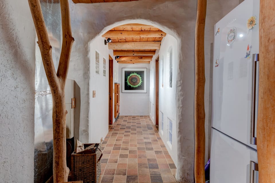 Full size fridge and hallway to bathroom 