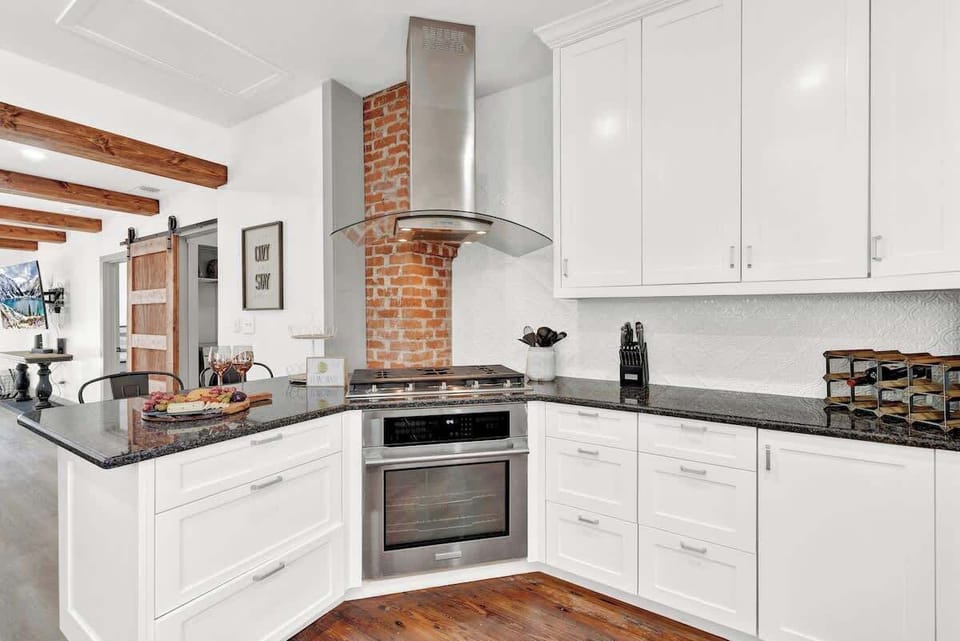 The ultimate cooking space, featuring top-of-the-line stainless steel appliances and a versatile gas stove.