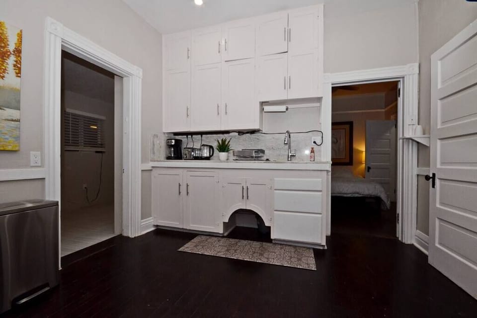 Original cabinets with granite countertops and deep stainless-steel sink.