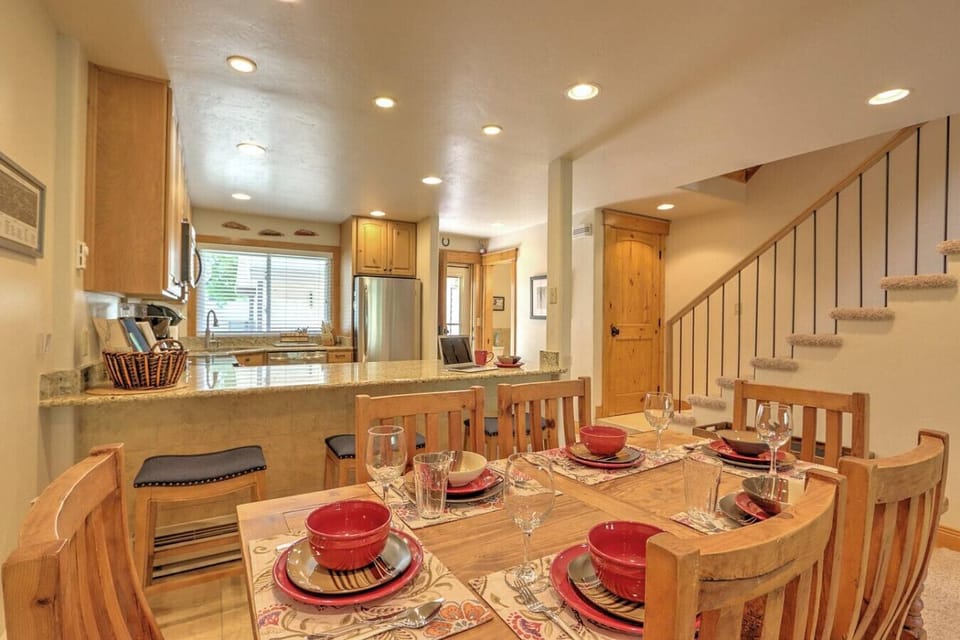 Dining area and breakfast bar seating with view into kitchen