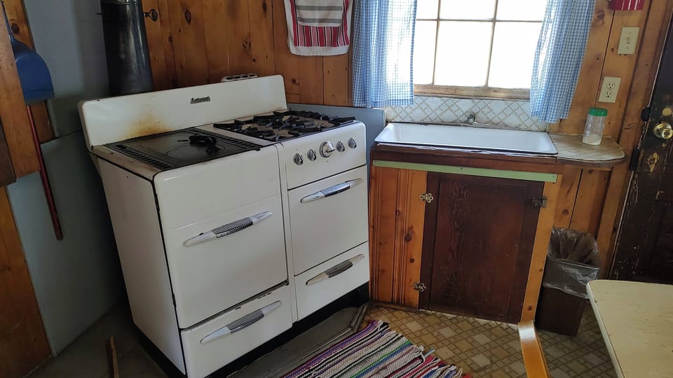 Cabin 7 is a cozy rustic cabin that features a half propane/ half wood-burning stove. (1)