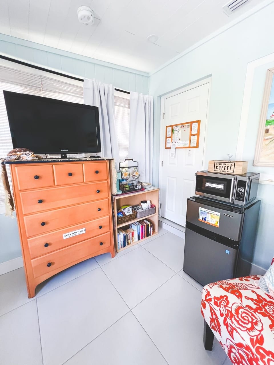 Roku tv, large chest of drawers, mini-fridge with freezer and a microwave.