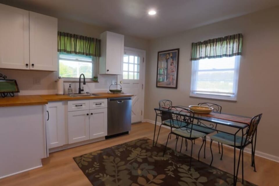A view of the kitchen table and side door leading to the side patio.  