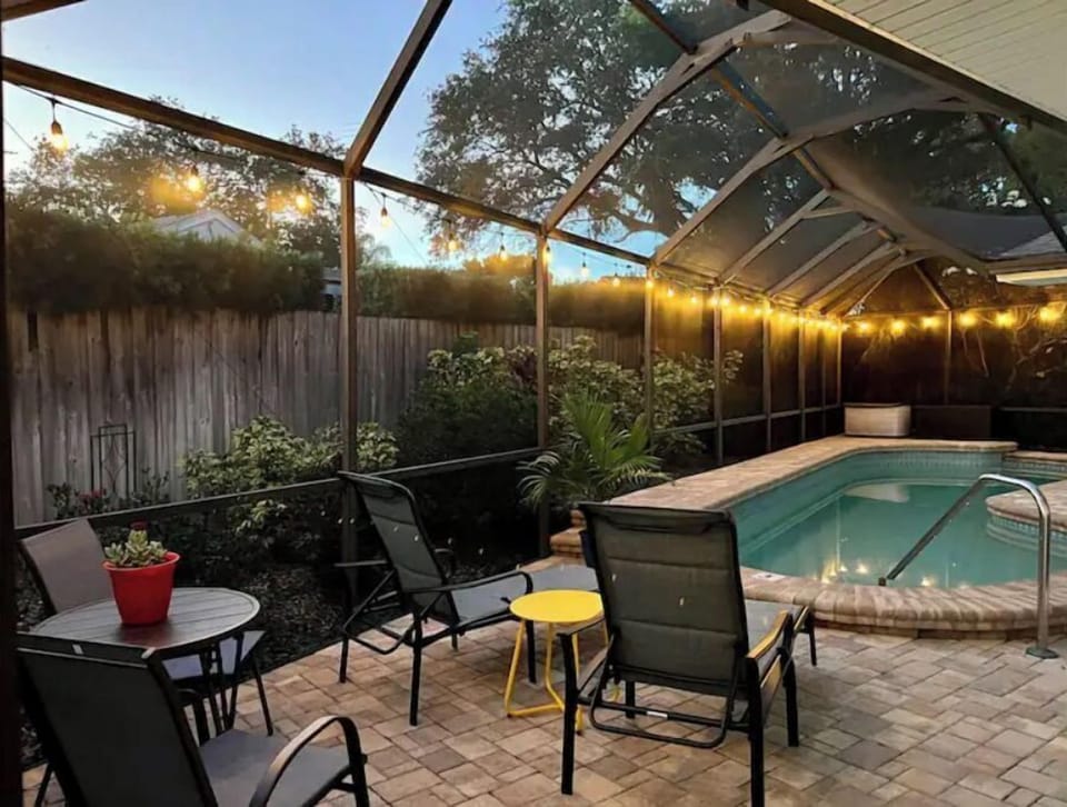 The backyard with the lights at night is magical