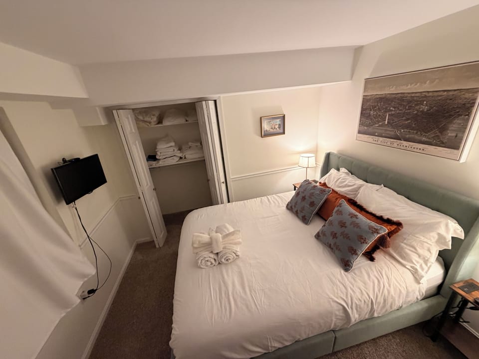 Queen size bed with small in-room TV.