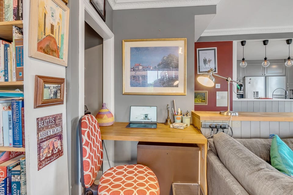 Living room with a large L shape sofa, coffee table, stairs to the Private rooftop garden, bookshelves full of books and Large Smart TV with Netflix.

you also have 4 large windows with panoramic views of the city and the best sunsets in Norwich.

In the corner, there is an indoor fireplace for romantic cosy evenings, we provide you with everything that you need to start a fire...