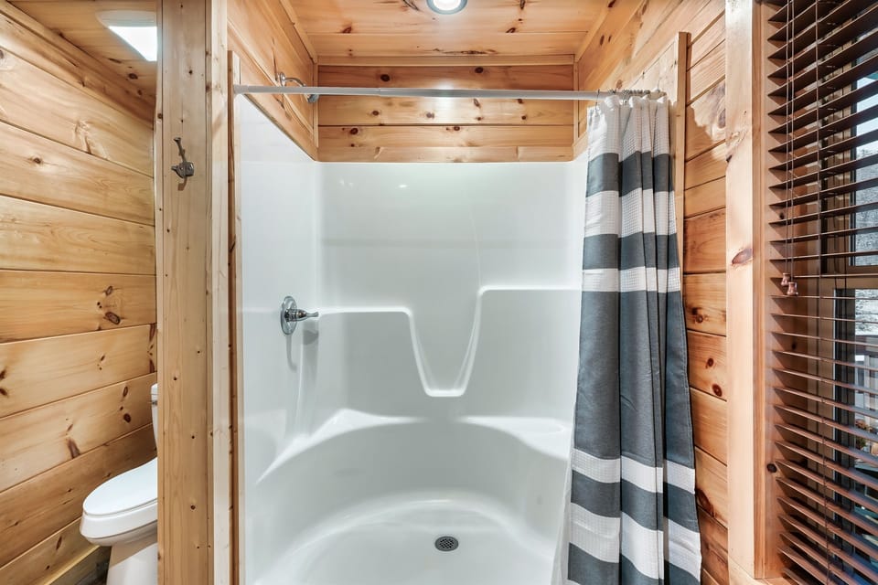 The main level ensuite bathroom features a spacious walk-in shower, adding an extra touch of convenience and comfort to your stay.
