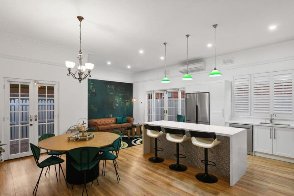 The kitchen is built around a central island and a Smeg stove — easy for a quiet breakfast or a proper dinner.