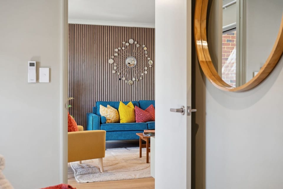 Bold mid-century living space with signature teal styling