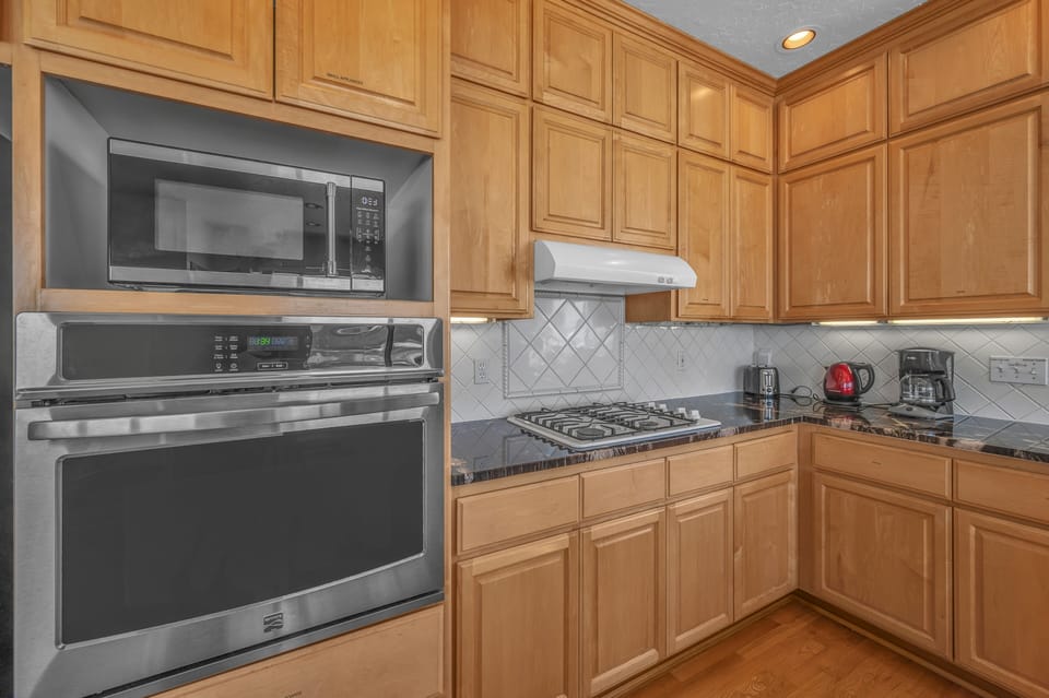 Your fully equipped kitchen features warm wood cabinets, granite counters, and all the appliances you need to create delicious meals.