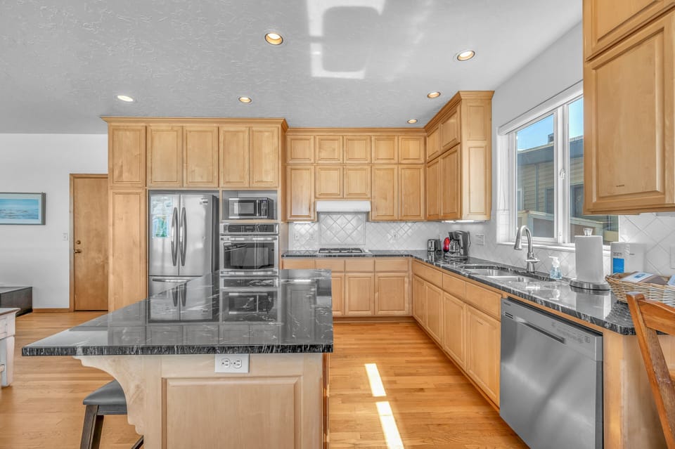 Your gourmet kitchen features granite countertops, stainless steel appliances, and warm wood cabinets perfect for home-cooked meals.