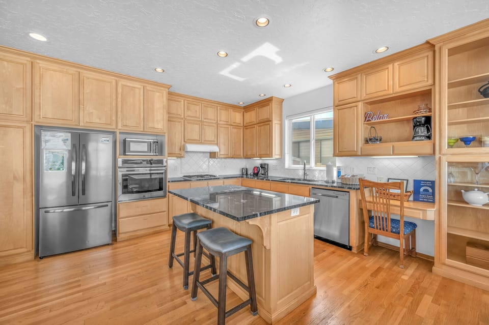 Your gourmet kitchen awaits with granite countertops, stainless steel appliances, and a breakfast bar perfect for morning coffee or casual meals.