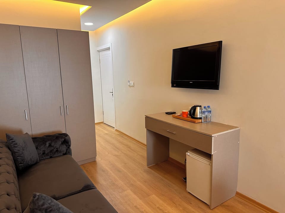 Quadruple Room | Living area | 82-inch LCD TV with cable channels, TV