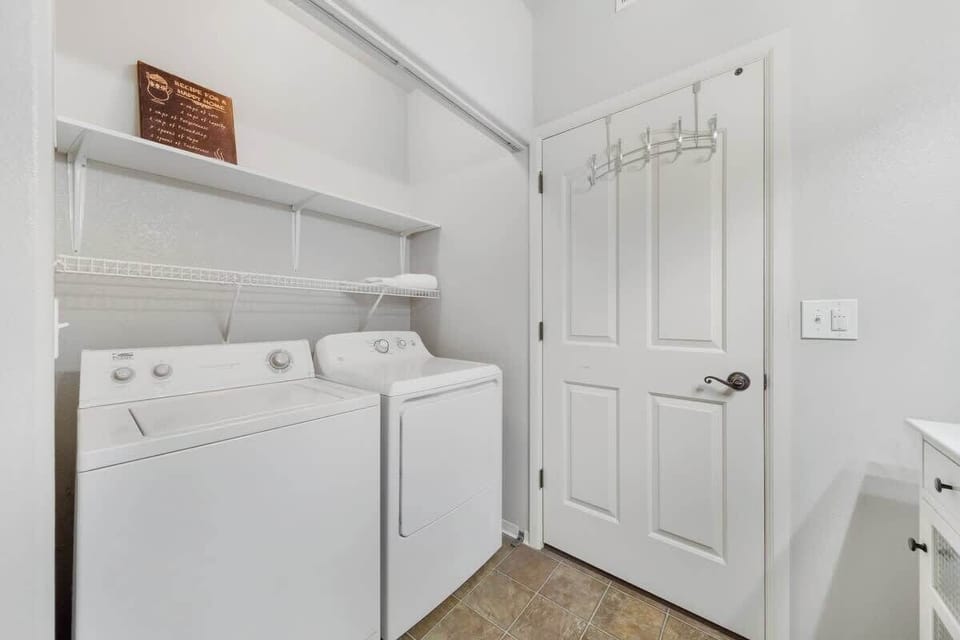 Laundry room inside of hall bathroom
