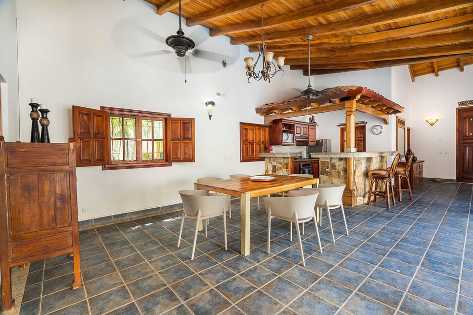 Dining area with open kitchen and access to the pool