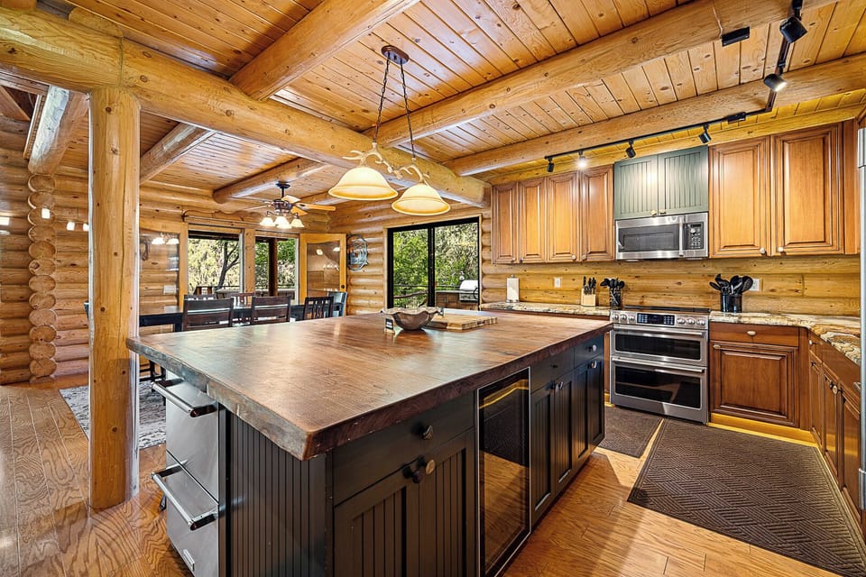 Rustic log kitchen, stone and wood details.