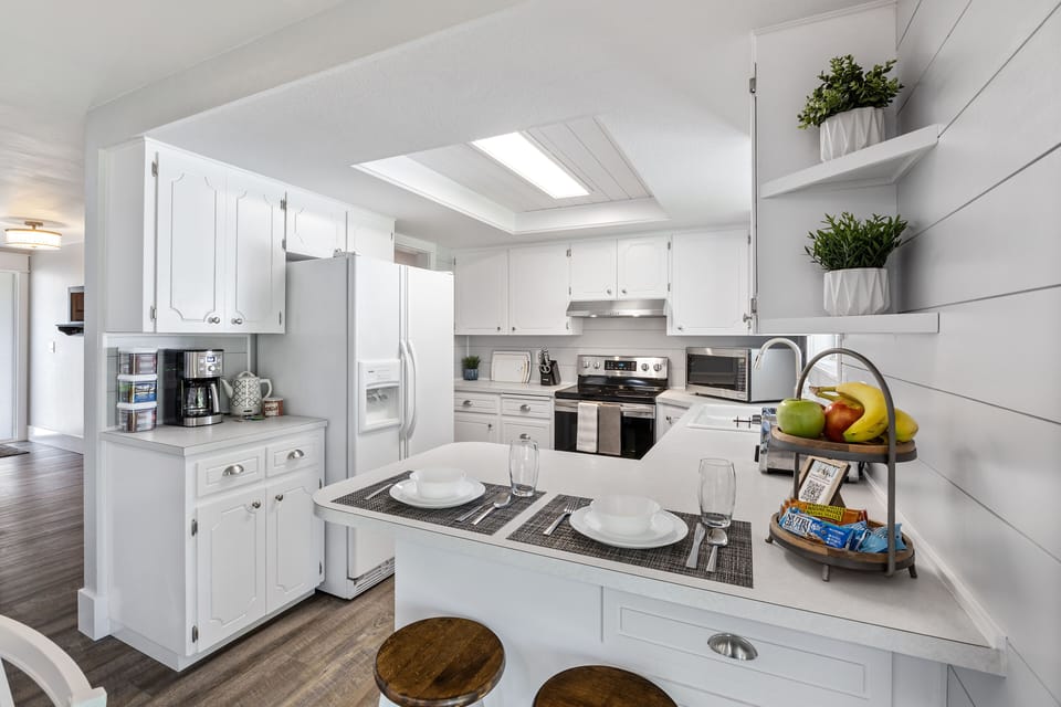 Kitchen with lots of amenities and 2 extra eating spaces set on counter.