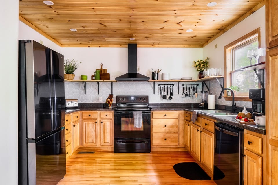 Fully stocked, updated kitchen with open shelving and a dishwasher