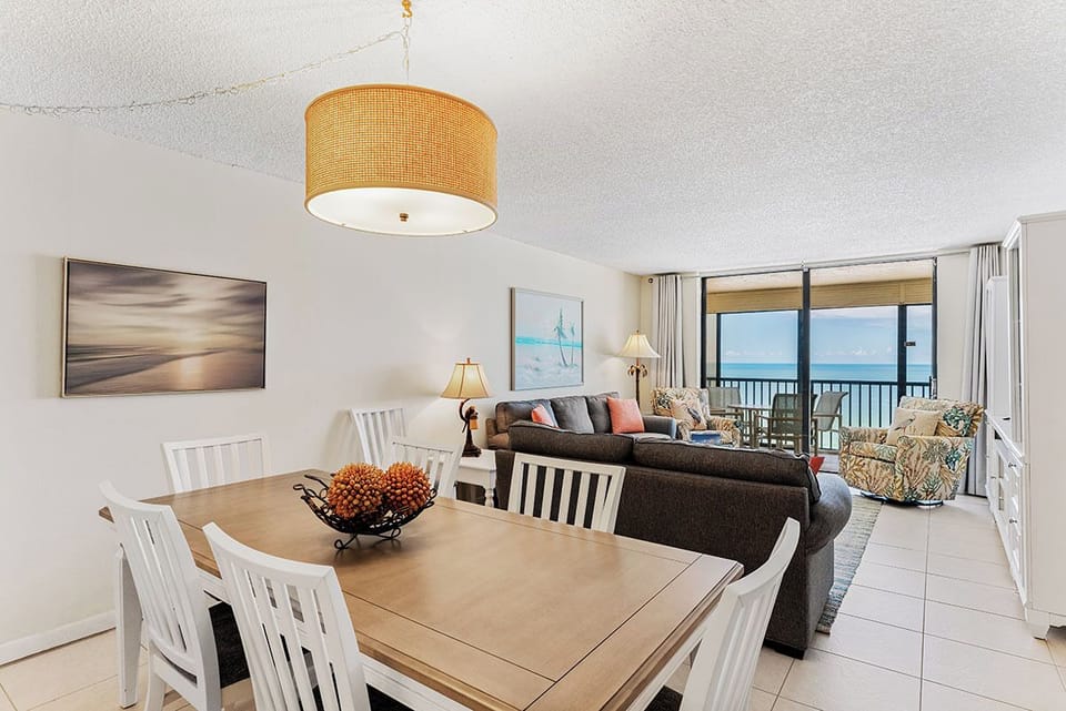 Unwind in your beachfront haven with stunning ocean views flowing seamlessly from dining to living areas through expansive windows.