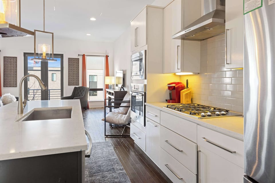 Bright white kitchen featuring stainless steel appliances and all the essential cooking tools for easy meals and entertaining.