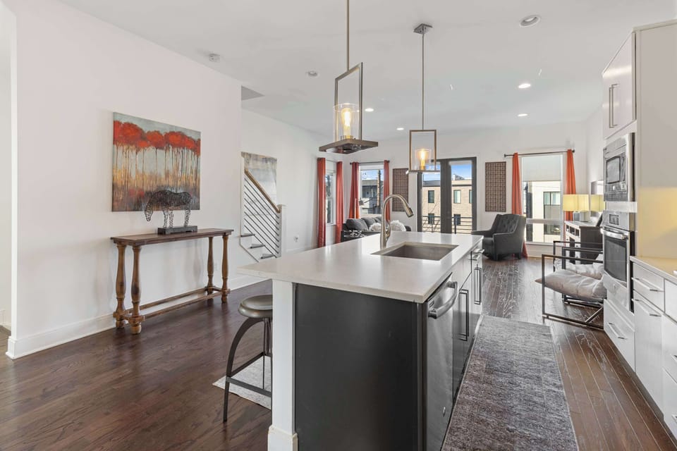 Modern white kitchen with stainless steel appliances and all the essentials needed for cooking, dining, and entertaining.