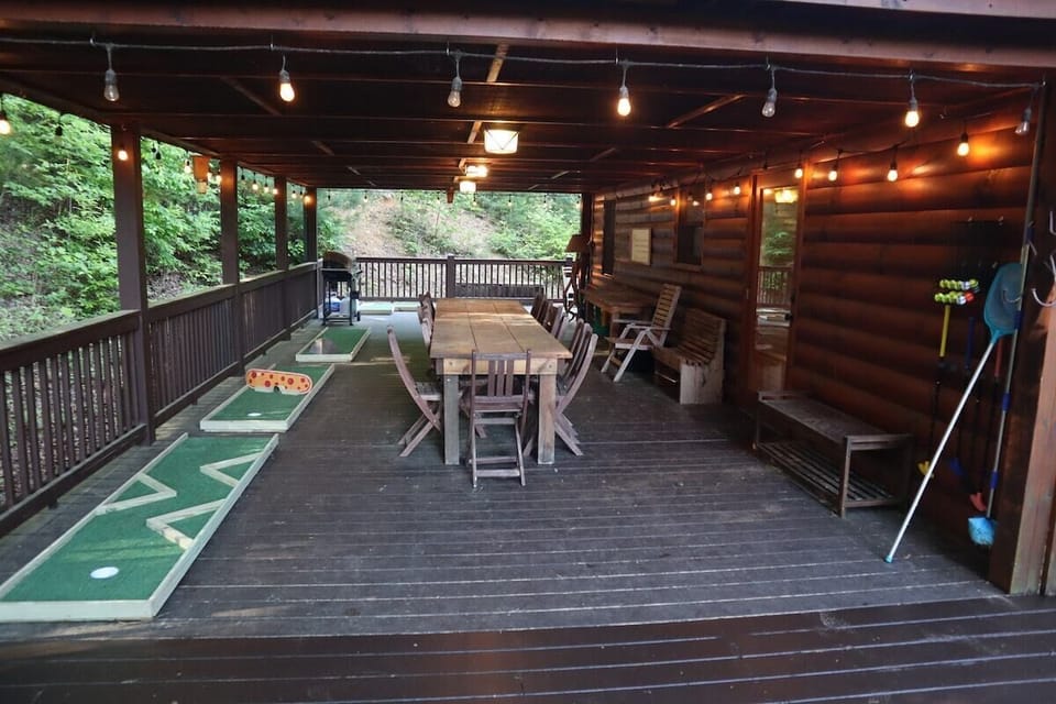 Covered Deck with seating, large connect 4 game, grill, and mini-golf