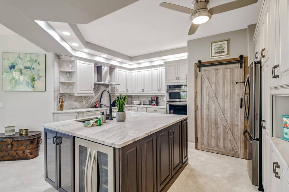 The upgraded appliances include a wine fridge, oven, microwave, French door refridgerator/freezer, dishwasher and smooth surface cooktop.