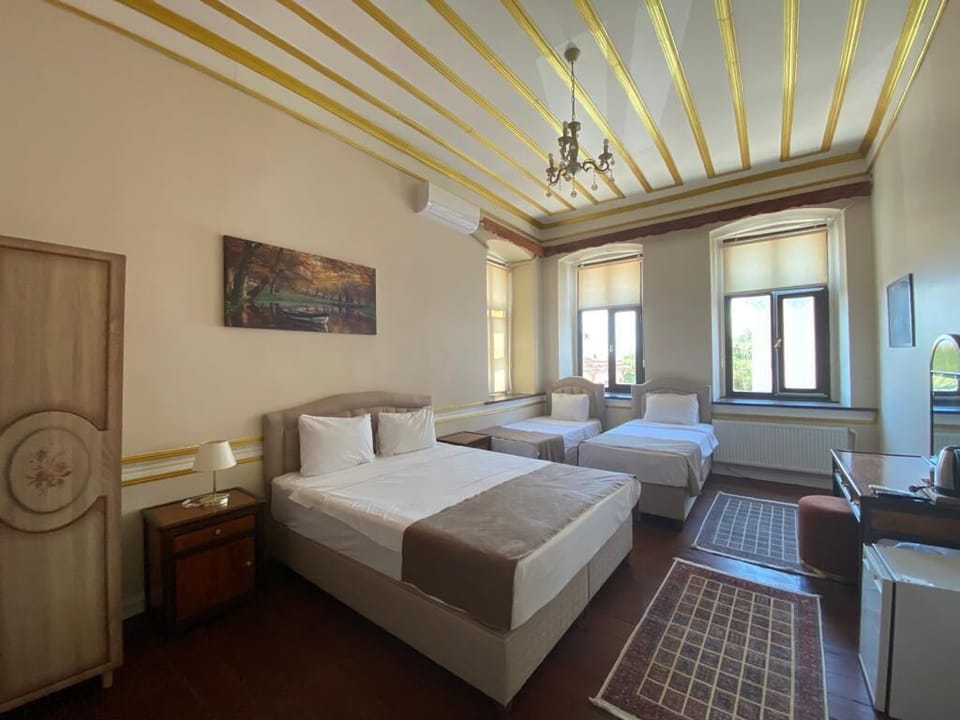 Family Quadruple Room | Premium bedding, minibar, in-room safe, individually decorated