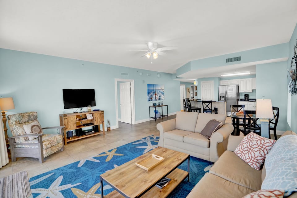 Relax in your spacious coastal haven with soft blue walls, comfortable seating, and ocean-themed touches that make you feel right at home.