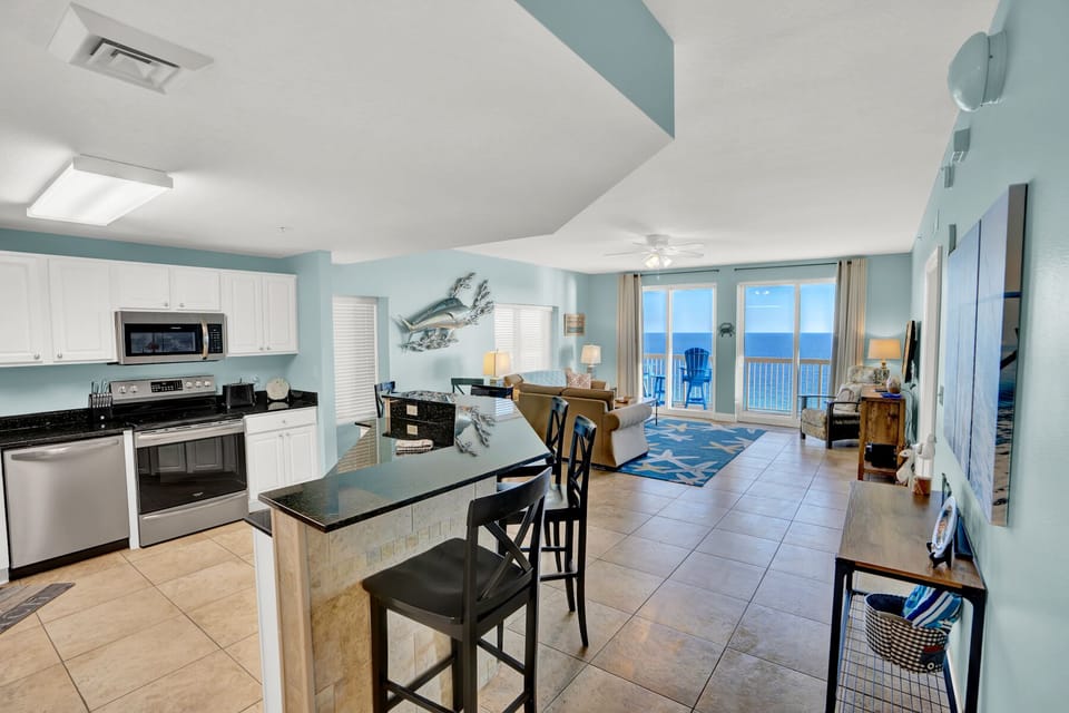 Your oceanfront condo features a fully equipped kitchen flowing into a bright living space with stunning sea views from your private balcony.