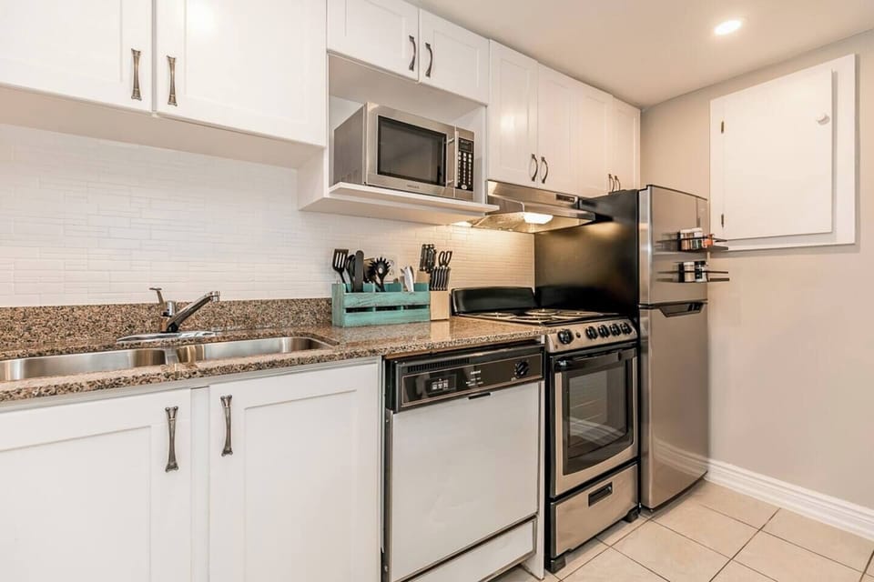 All stocked with dishes, pots and pans. Double sink, dishwasher, new stove and more.