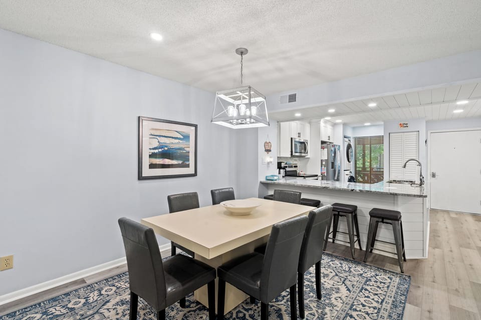 Gather around the spacious dining table for meals and conversation, with the bright open kitchen just steps away for easy entertaining.