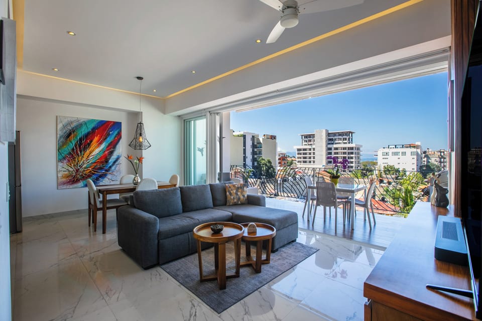 Relax in your stylish living space with floor-to-ceiling windows opening to your private balcony overlooking the vibrant city.