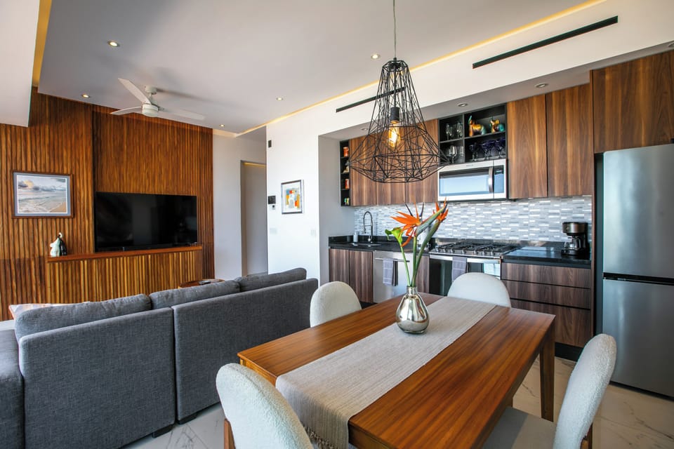 Your stylish open-plan space blends warm wood tones with modern comfort, creating the perfect backdrop for memorable meals and relaxing evenings together.