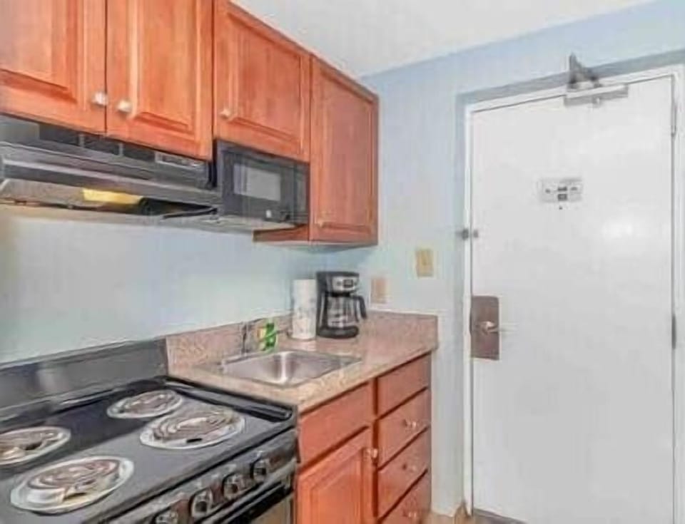 Fully Equipped Kitchenette with Full-Size Fridge Includes stovetop, microwave, refrigerator, coffee 