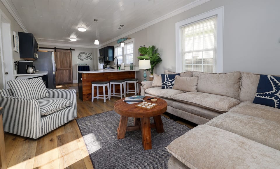 Living room area opens into the kitchen