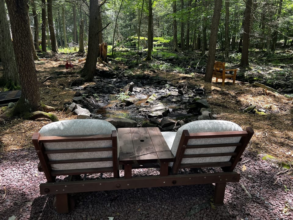 Sitting area in backyard near stream