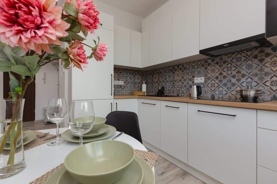 The kitchen's sleek design includes all necessary cookware and utensils. 