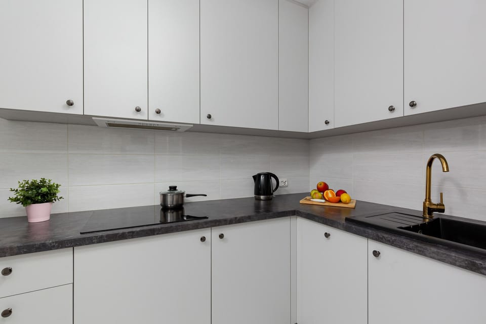 The kitchen's stylish decor complements the apartment's overall design.