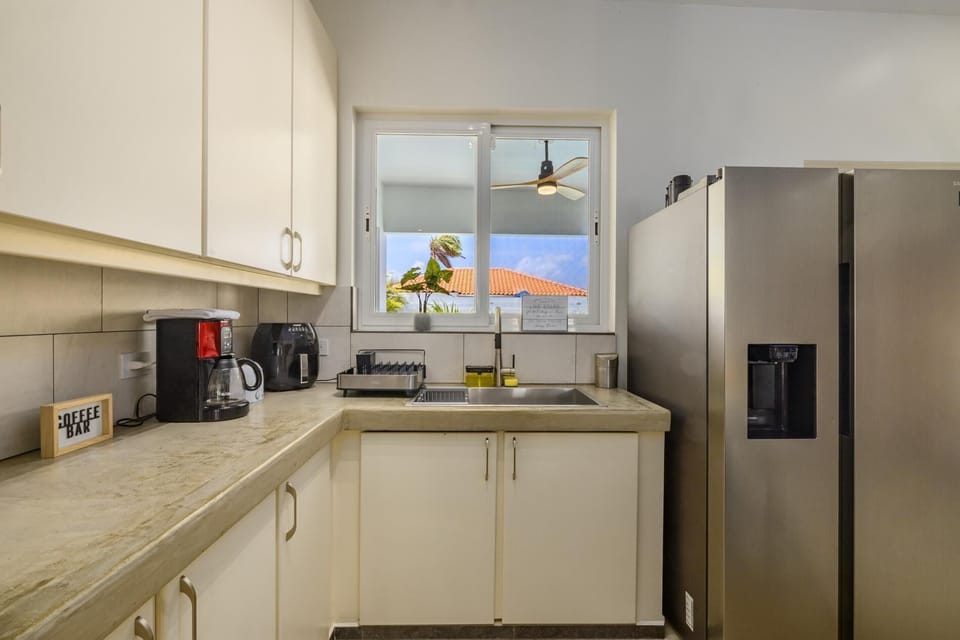 The full kitchen has a large kitchen counter that adds more dining space for your family.